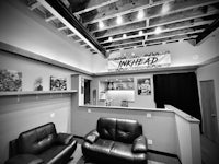 a black and white photo of a room with leather furniture